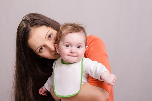 Portrait of mother and baby at the hands of six mothers