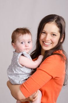 Portrait of mother and baby at the hands of six mothers
