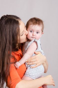 Portrait of mother and baby at the hands of six mothers