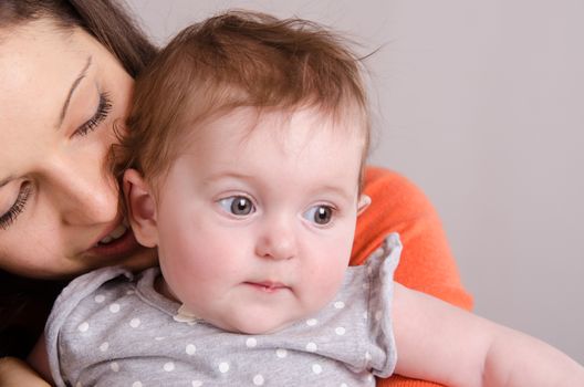 Portrait of mother and baby at the hands of six mothers