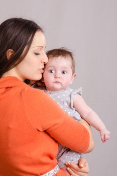 Portrait of mother and baby at the hands of six mothers
