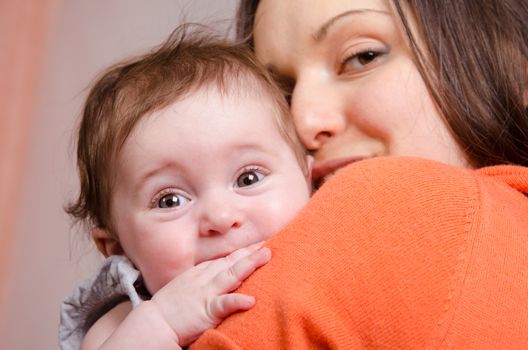 Portrait of mother and baby at the hands of six mothers
