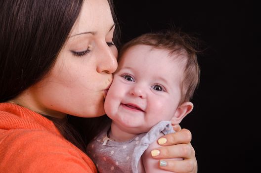 Portrait of mother and baby at the hands of six mothers