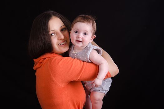 Portrait of mother and baby at the hands of six mothers