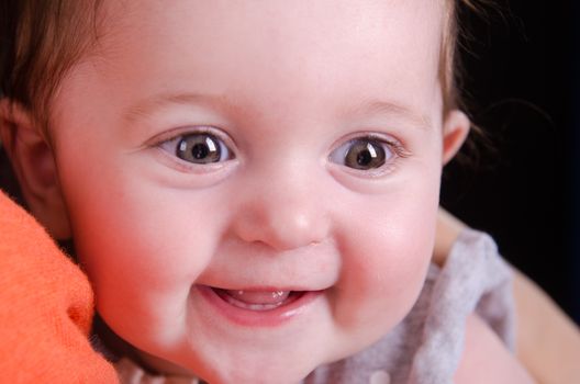 Portrait of a six month baby on mother hands