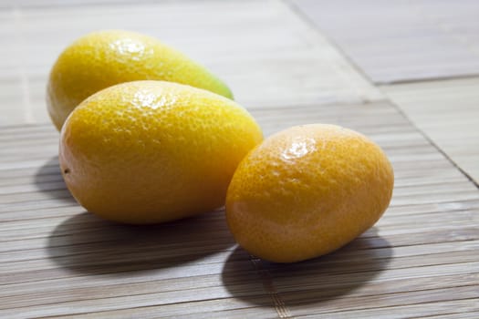 Fresh fruit kumquat on the wooden board.