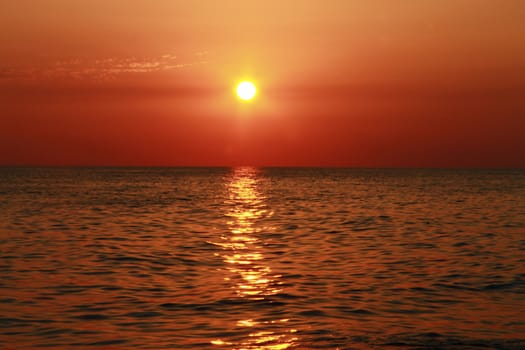 Summer sunset on the beach of the sea