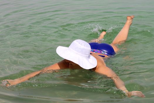 Woman in the water of the Dead sea Israel