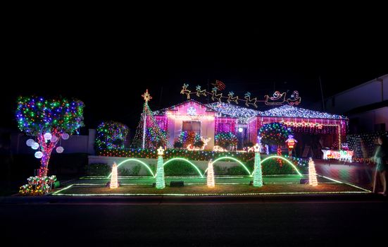BEAUMONT HILLS, AUSTRALIA - DECEMBER 24, 2015;  Over 60000  Christmas lights decorations on house and manicured gardens create a joyful wonderland and  draw crowds of visitors each year.  The christmas display helps raise money in the community for charity by generous donations by visitors. 