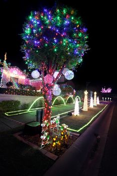BEAUMONT HILLS, AUSTRALIA - DECEMBER 24, 2015;  Christmas lights decorations on house and manicured gardens create a joyful wonderland and  draw crowds of visitors each year with over 60000 lights with  music syncs  and donations are raised for charity
