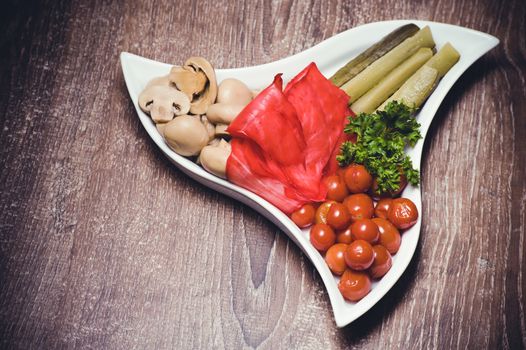 set of marinated vegetables on white plate 