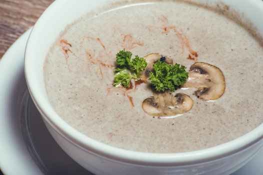 tasty mushroom cream soup in white bowl