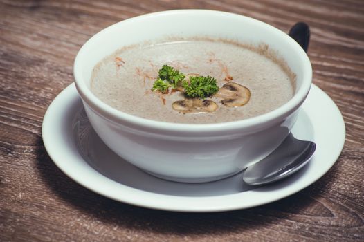 tasty mushroom cream soup in white bowl