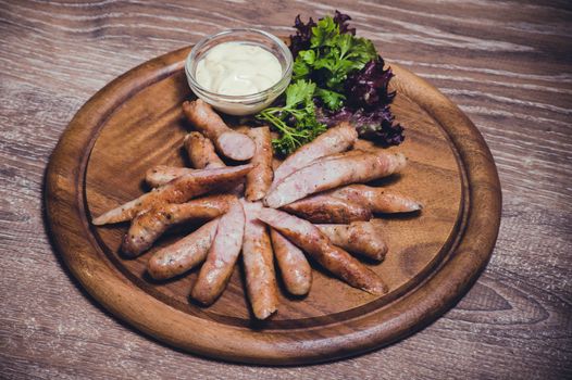 pork fried sausages with dip on wooden plate 