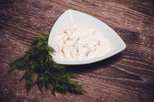 tartar sauce in white bowl with dill 