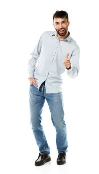 A young bearded man smiling with a finger up isolated on white background