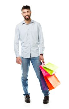 Handsome man holding shopping bags. Christmas and holidays concept