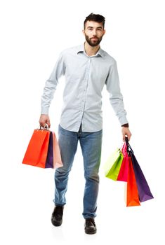 Handsome man holding shopping bags. Christmas and holidays concept