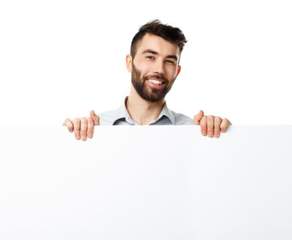 A young bearded man showing blank signboard, isolated over white background