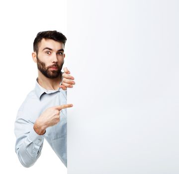 A young bearded man showing blank signboard, isolated over white background