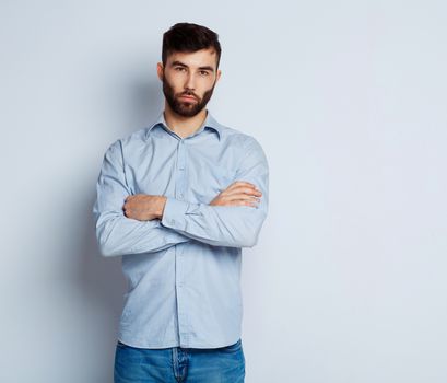 A young bearded man with a serious expression on his face