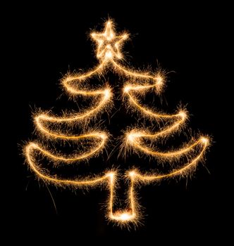 Christmas tree made by sparkler on a black background