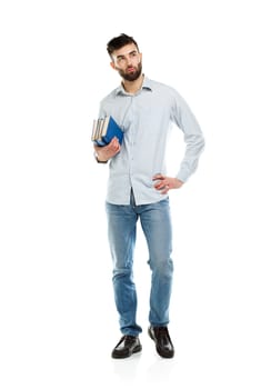 Young bearded smiling man with books in hands on white background