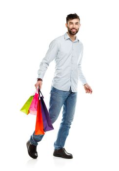 Handsome man holding shopping bags. Christmas and holidays concept