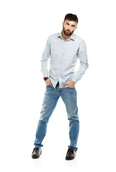 A young bearded man with a serious expression on his face isolated on white background