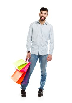 Handsome man holding shopping bags. Christmas and holidays concept