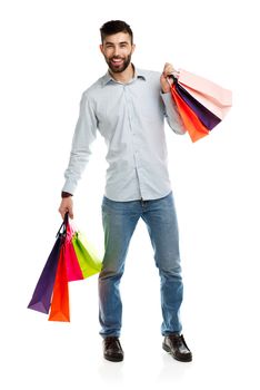 Handsome man holding shopping bags. Christmas and holidays concept