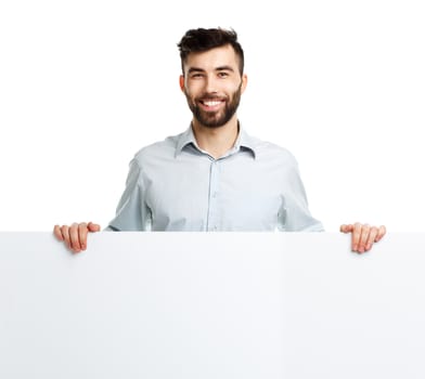 A young bearded man showing blank signboard, isolated over white background