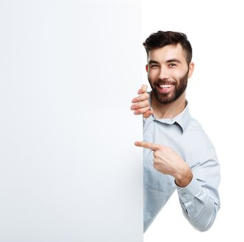 A young bearded man showing blank signboard, isolated over white background