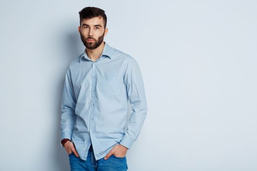 A young bearded man with a serious expression on his face