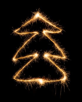 Christmas tree made by sparkler on a black background