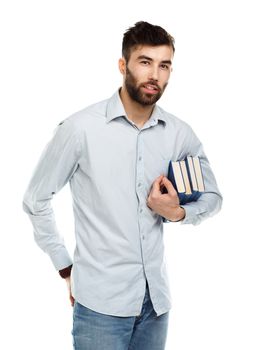 Young bearded smiling man with books in hands on white background