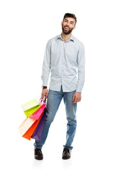 Handsome man holding shopping bags. Christmas and holidays concept