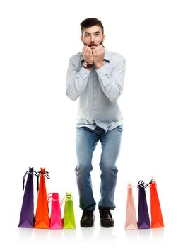 Handsome man with shopping bags is shocked. Christmas and holidays concept