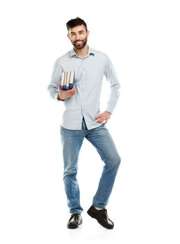 Young bearded smiling man with books in hands on white background