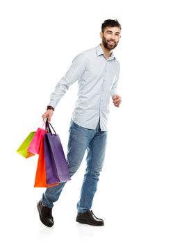 Handsome man holding shopping bags. Christmas and holidays concept