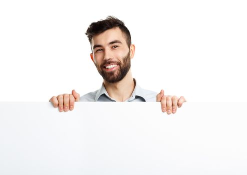 A young bearded man showing blank signboard, isolated over white background