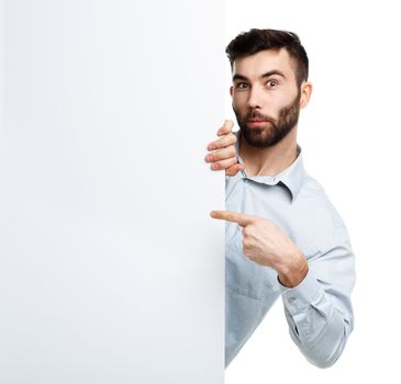 A young bearded man showing blank signboard, isolated over white background