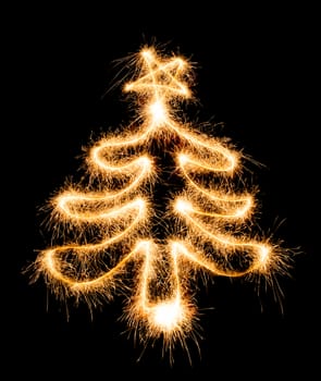 Christmas tree made by sparkler on a black background