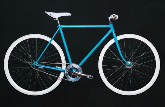 Stylish womens blue bicycle isolated on black background