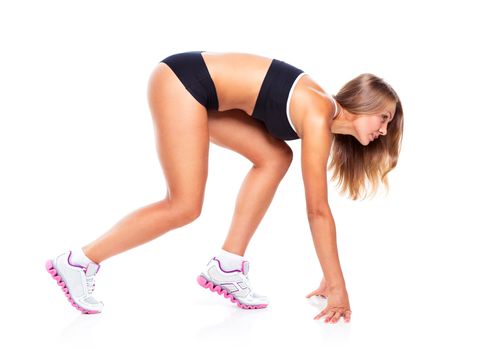 Young sports girl does exercises on a white background