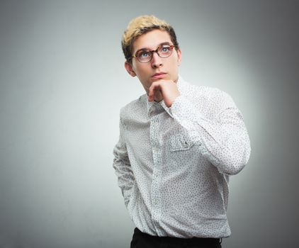 Young man with glasses thinking - feelings and emotions