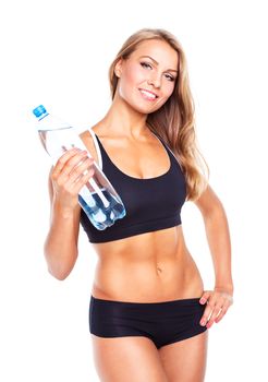 Young athletic girl with bottle of water on white background