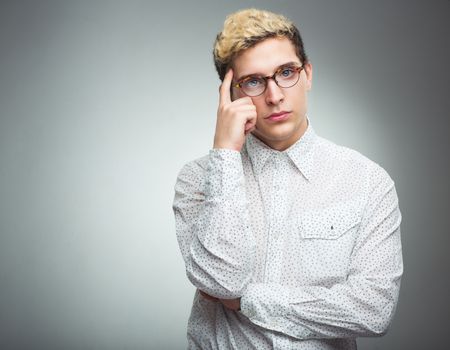 Young man with glasses thinking - feelings and emotions