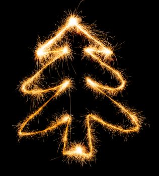 Christmas tree made by sparkler on a black background