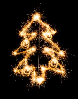 Christmas tree made by sparkler on a black background